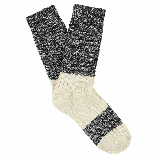 A pair of melange block socks in black and ecru colors, crafted from cotton blend materials and made in Portugal