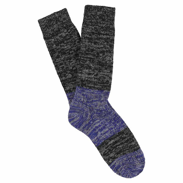 A pair of melange block socks in black and bright blue colors, crafted from cotton blend yarns and made in Portugal