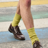 Man wearing khaki ribbed crew socks by Escuyer, made in Portugal