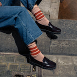 Woman wearing pink and green striped crew socks by Escuyer, made in Portugal