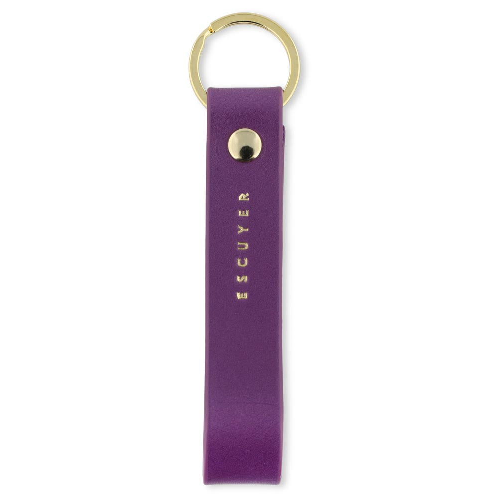 Escuyer violet leather keychain — Italian vegetable tanned leather tab with gold metal ring and gold Escuyer logo