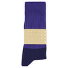 Purple sock with a gold label on a white background