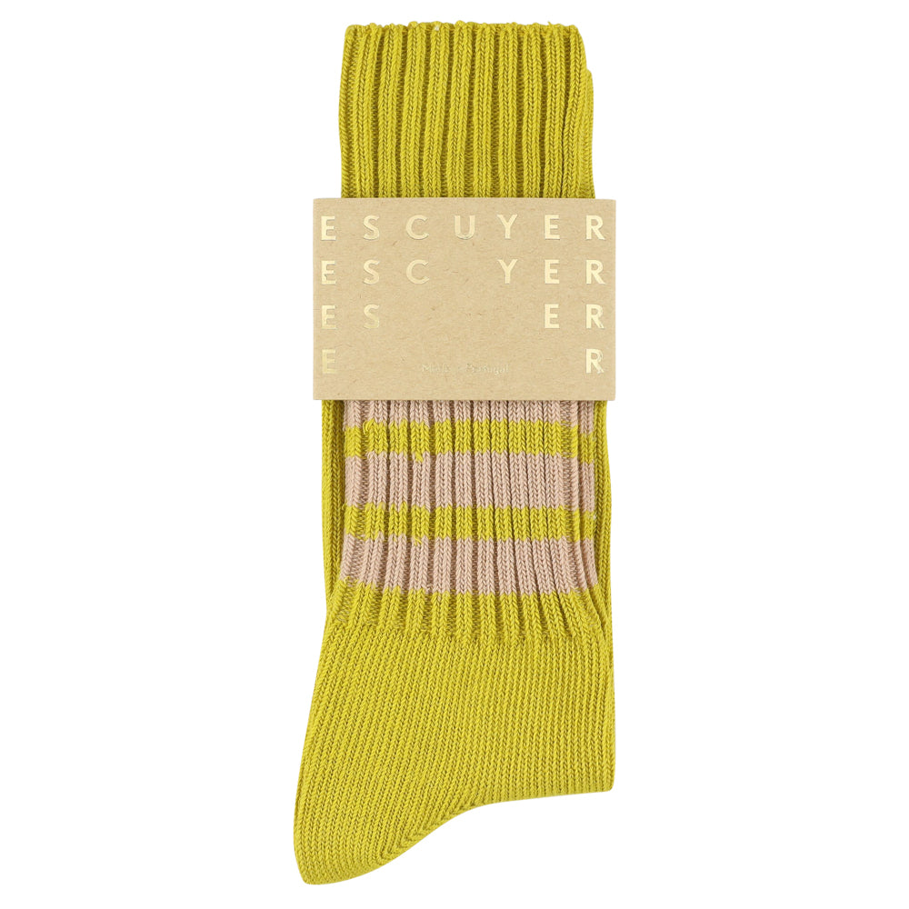 Yellow sock with a beige label on a white background