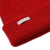 Side view of red ribbed merino wool beanie with folded cuff