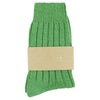 Wool and Cashmere green socks with a beige label on a white background