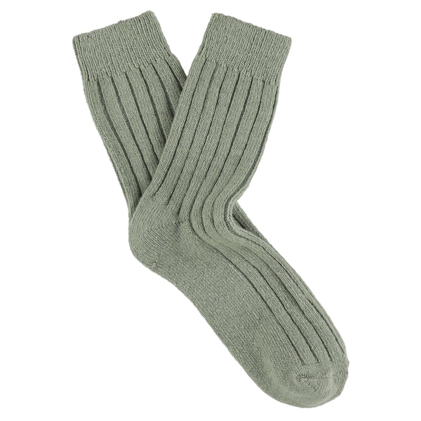 Pair of green wool and cashmere socks on a white background