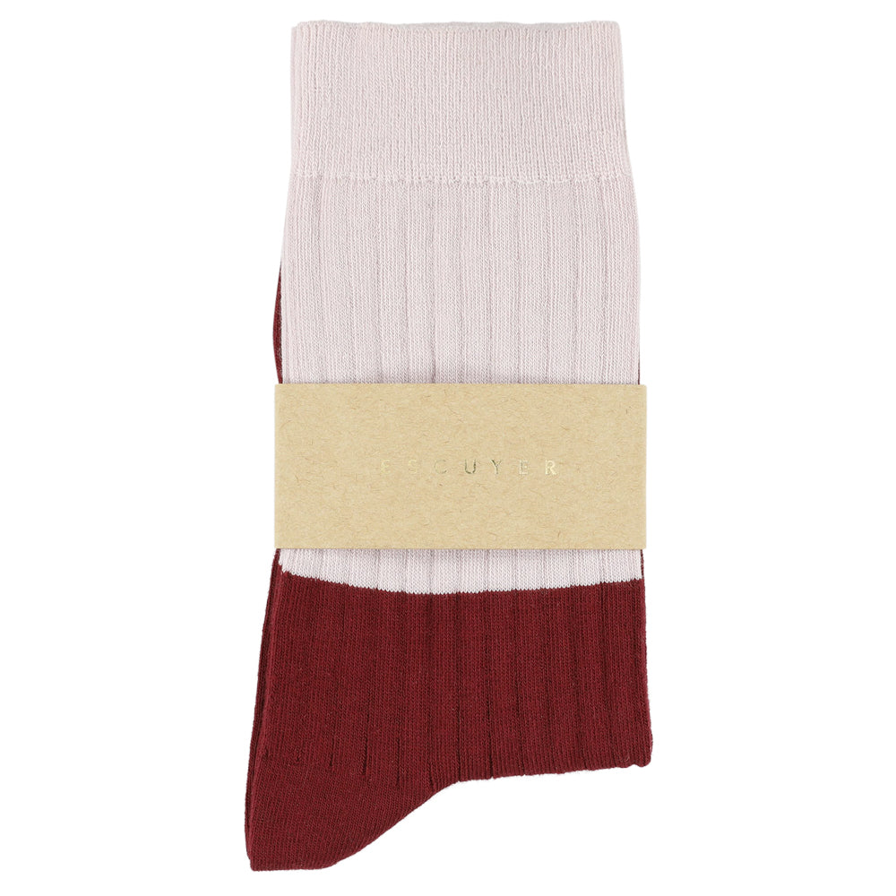 Pair of socks with a beige band displaying a logo on a white background