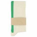 Close-up of Escuyer ecru and bright green combed cotton knee high socks with hand-linked toe