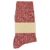 Red and white patterned sock with a beige band on a white background