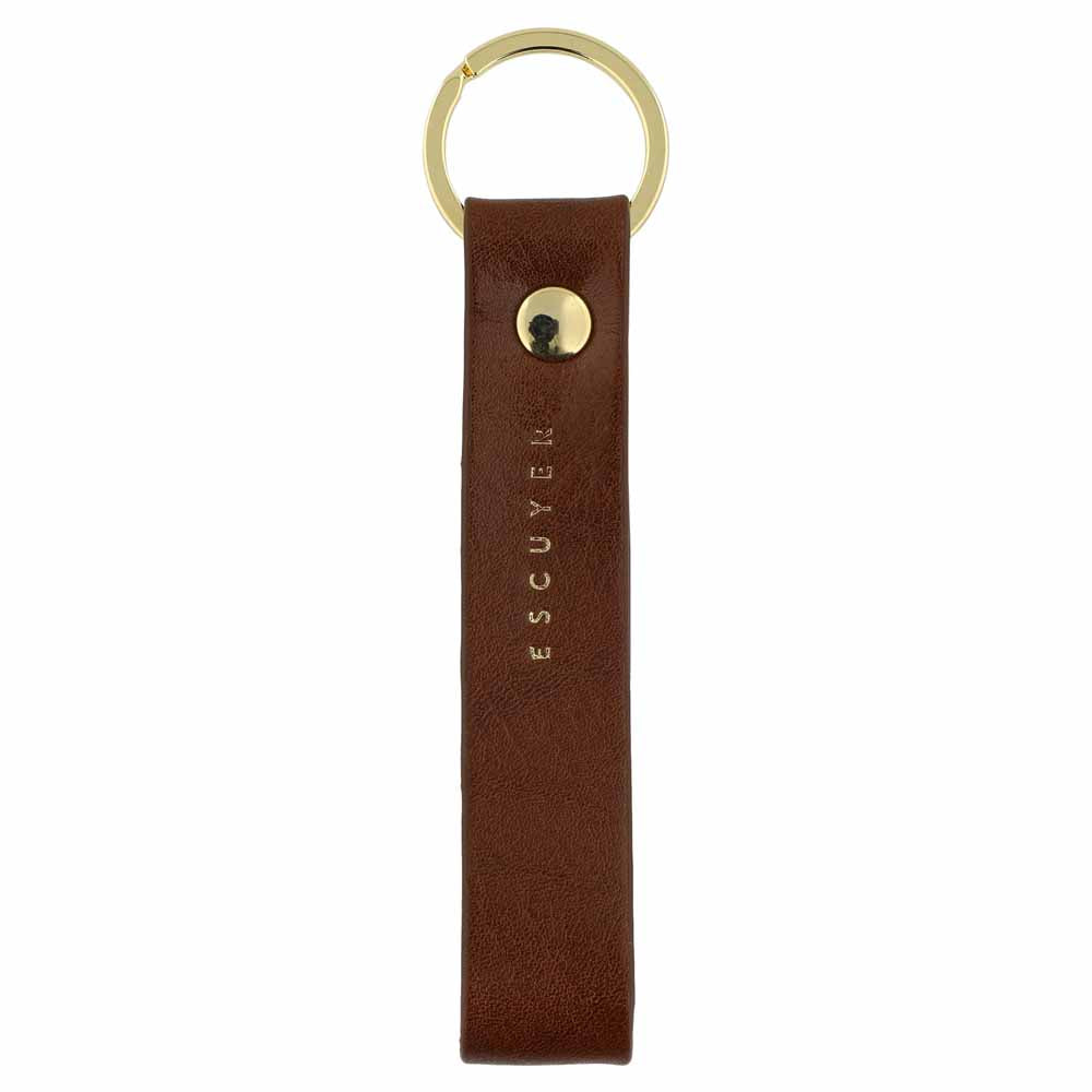 Escuyer light brown leather keychain — Italian vegetable tanned leather tab with gold metal ring and gold Escuyer logo