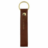 Escuyer light brown leather keychain — Italian vegetable tanned leather tab with gold metal ring and gold Escuyer logo
