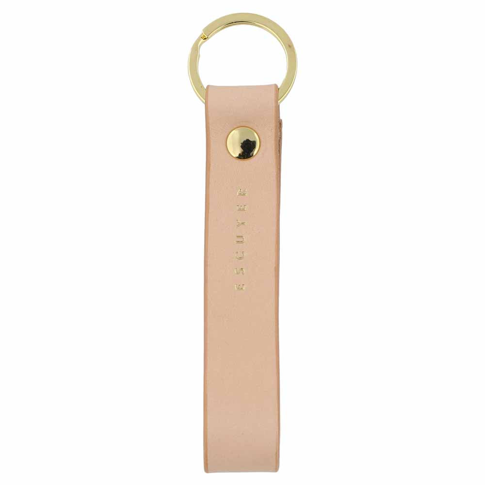 Escuyer pink leather keychain — Italian vegetable tanned leather tab with gold metal ring and gold Escuyer logo
