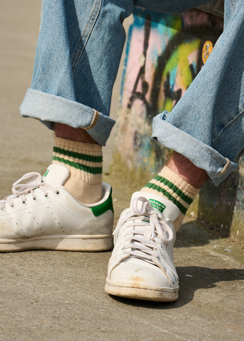 Man wearing Escuyer Men Striped Ankle Socks Ecru / Yellow / Blue with Stan Smith sneakers — retro summer style