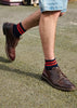 Man wearing classic brown shoes with red and navy striped ankle socks crafted from cotton yarns made in Portugal