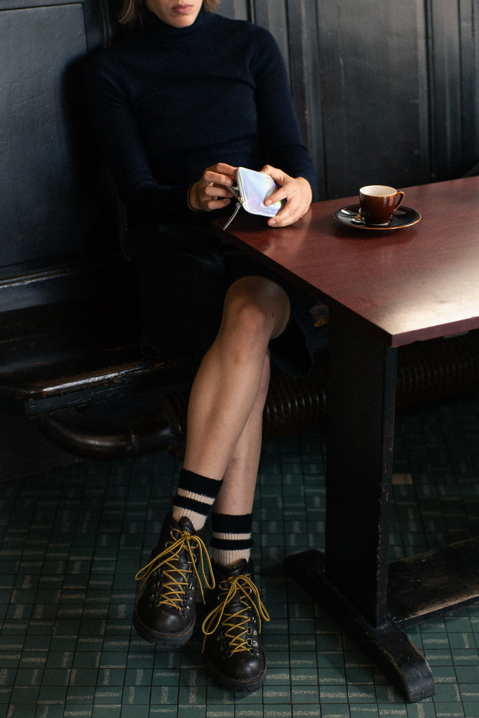 Person wearing black socks with ecru stripes made of wool and cashmere (made in Portugal)