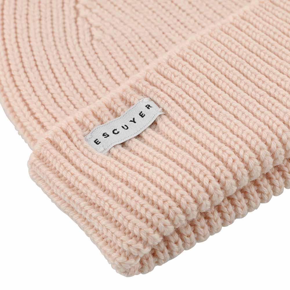 Side view of pink ribbed merino wool beanie with folded cuff